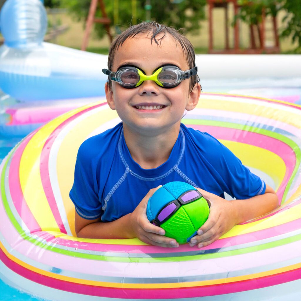 smiling boy playing in swimming pool
