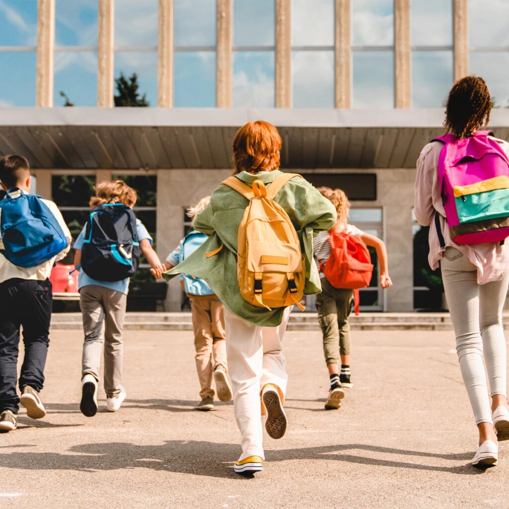 school children going inside school building
