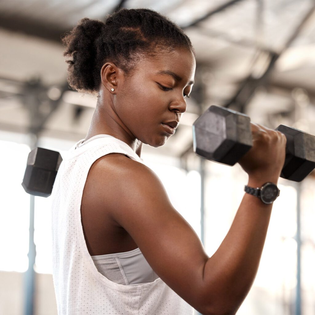 woman working out with a dumbbell