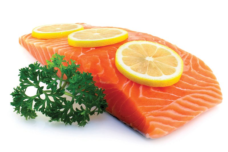 salmon with lemon slices on top