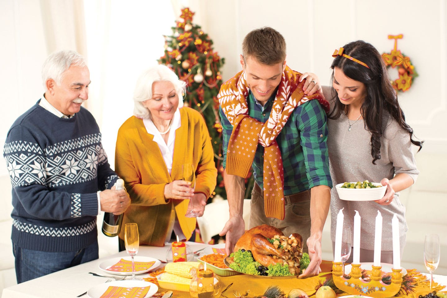 Family standing over a Thanksgiving dinner