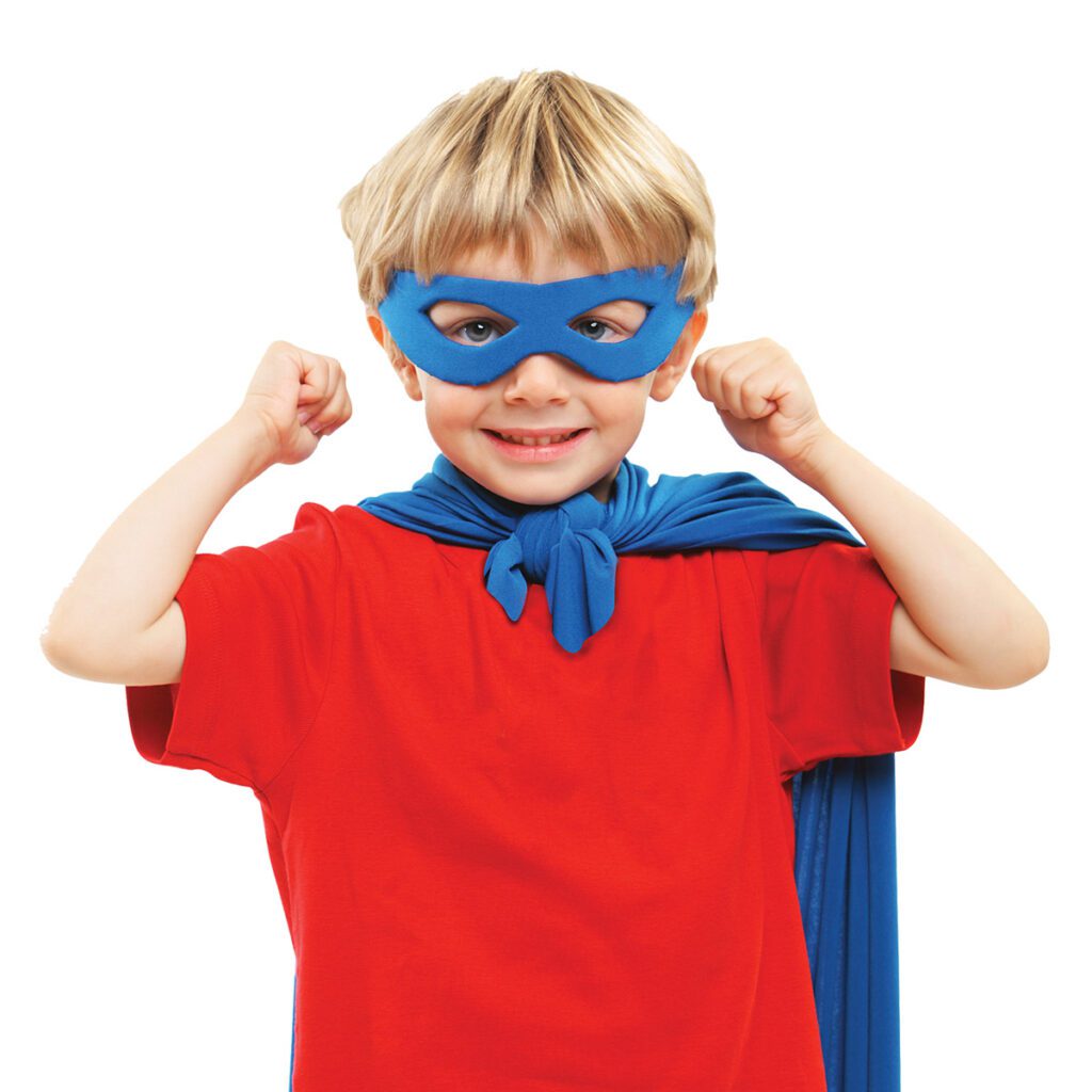 boy wearing superhero mask and blanket cape