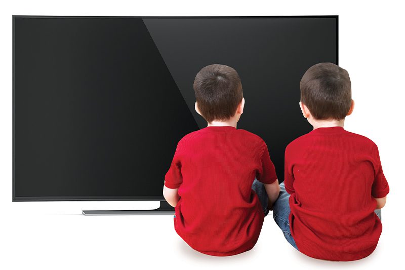 kids sitting in front of a tv