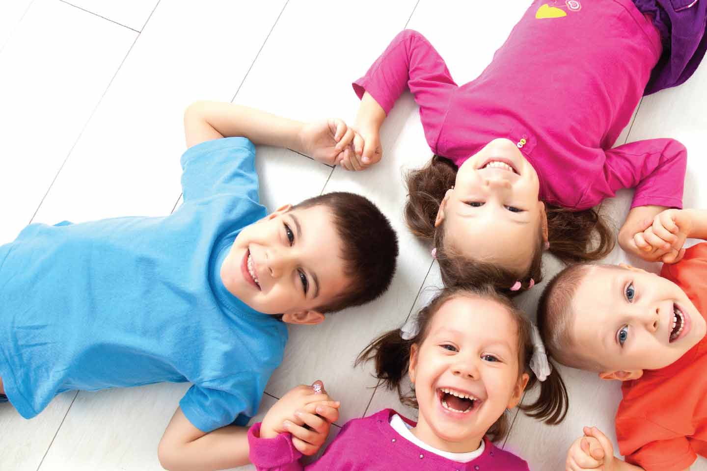 Kids lying down and smiling