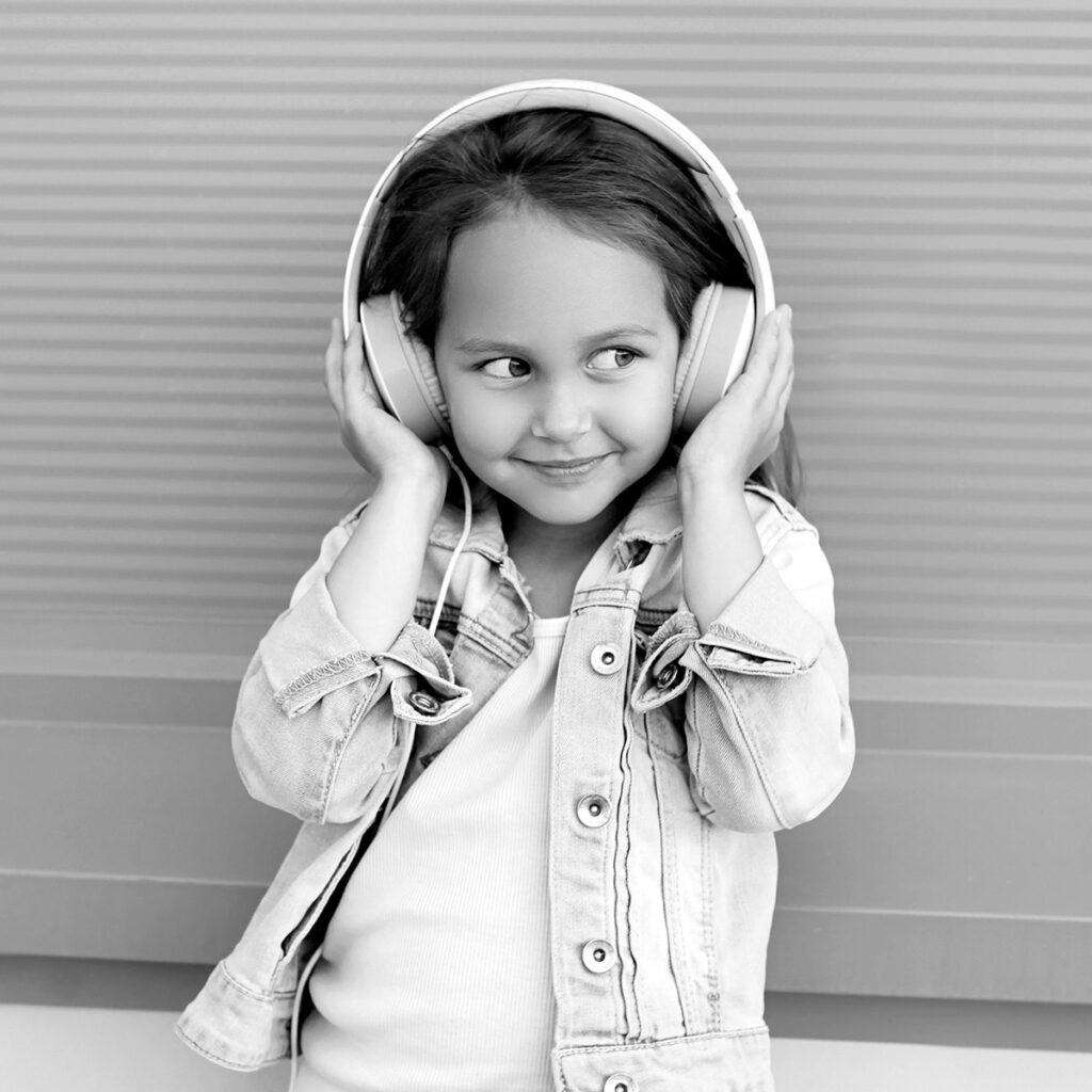 child enjoying her music through headphones