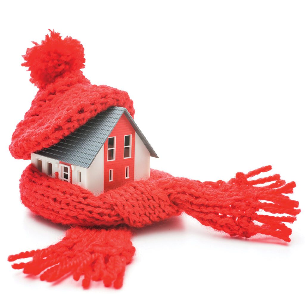miniature house with red knit hat and scarf