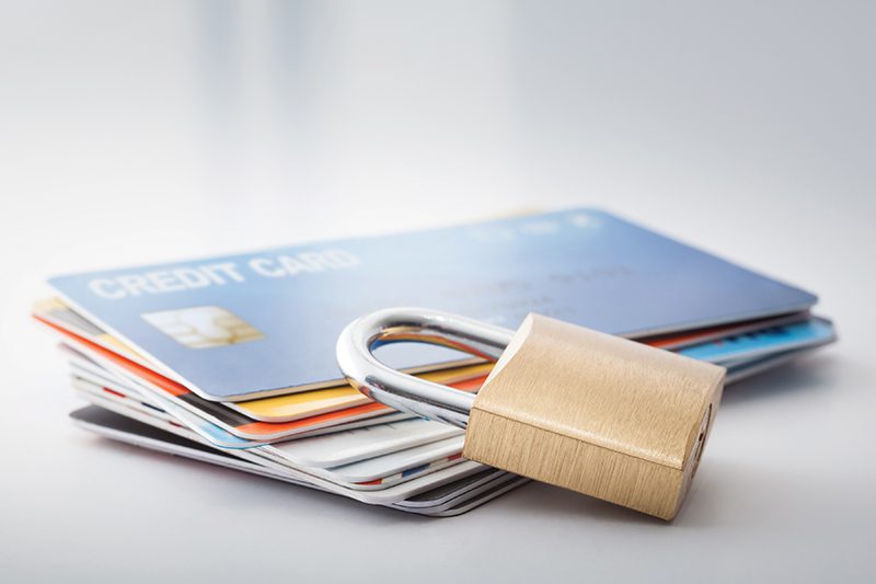 a stack of credit cards with a lock