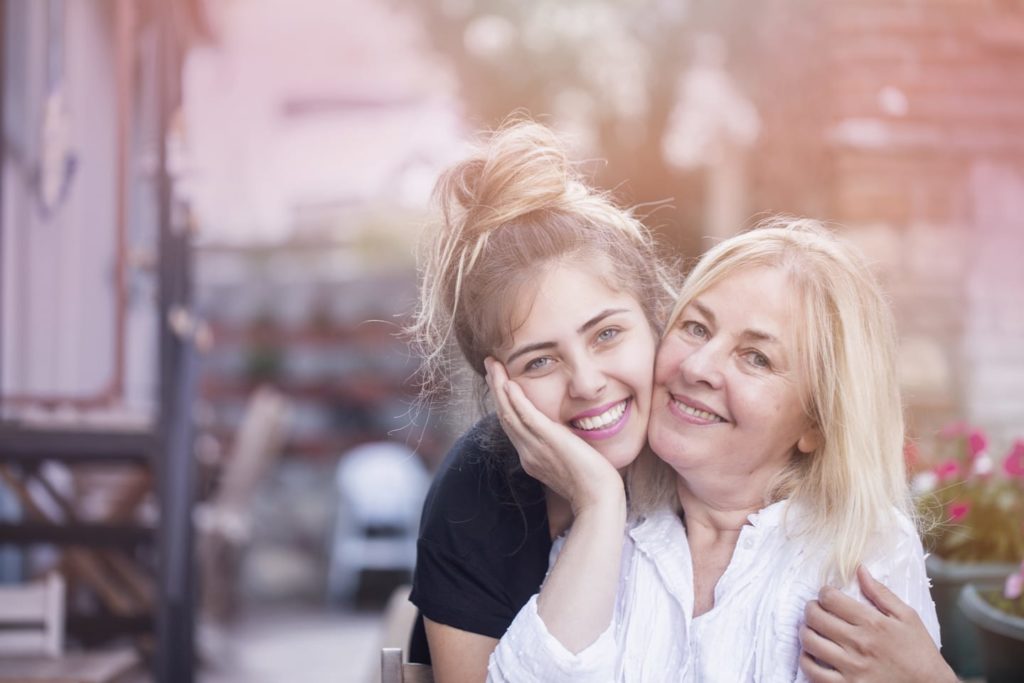 mother and daughter smiling in a photo together