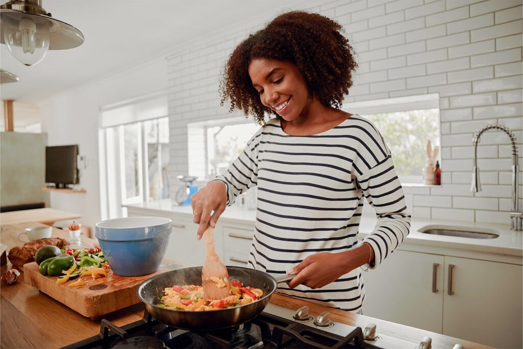 woman cooking on the stove in the kitchen