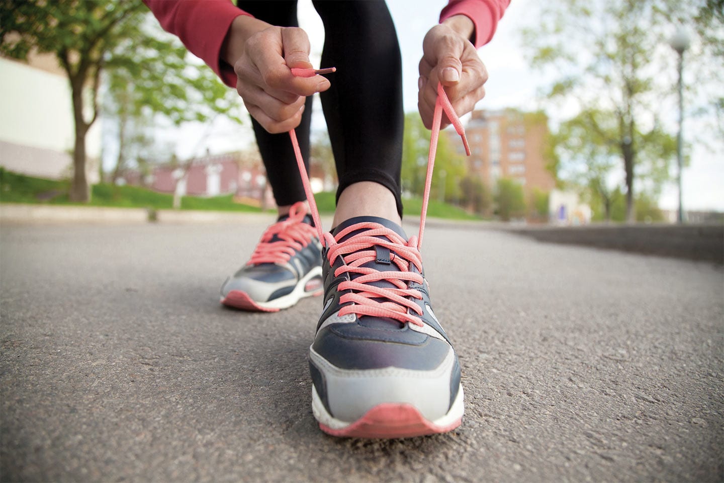 woman tying her tennis shoe exercising to prevent deep vein thrombrosis in chattanooga
