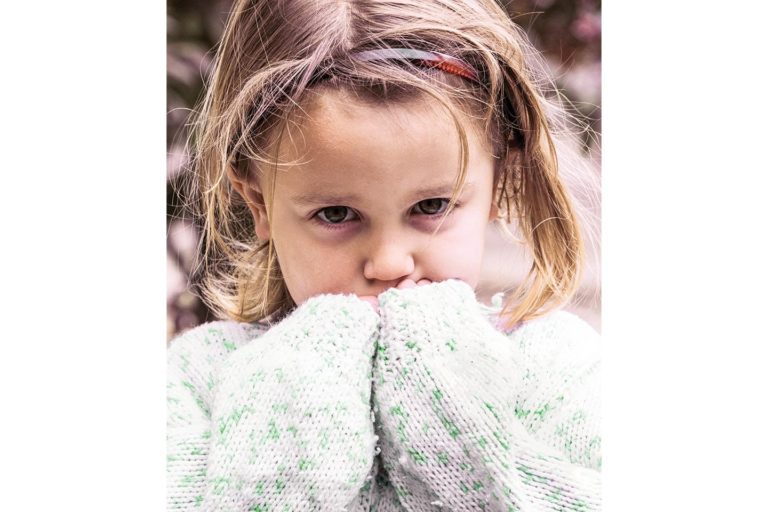 shy little girl wearing sweater