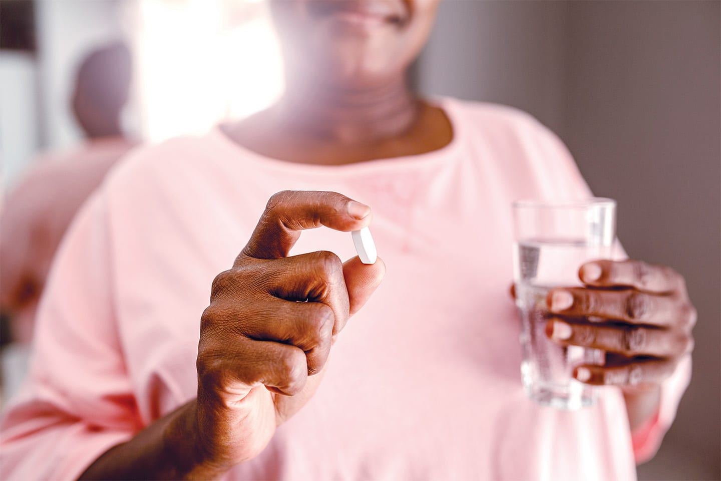 woman preparing to take a pill