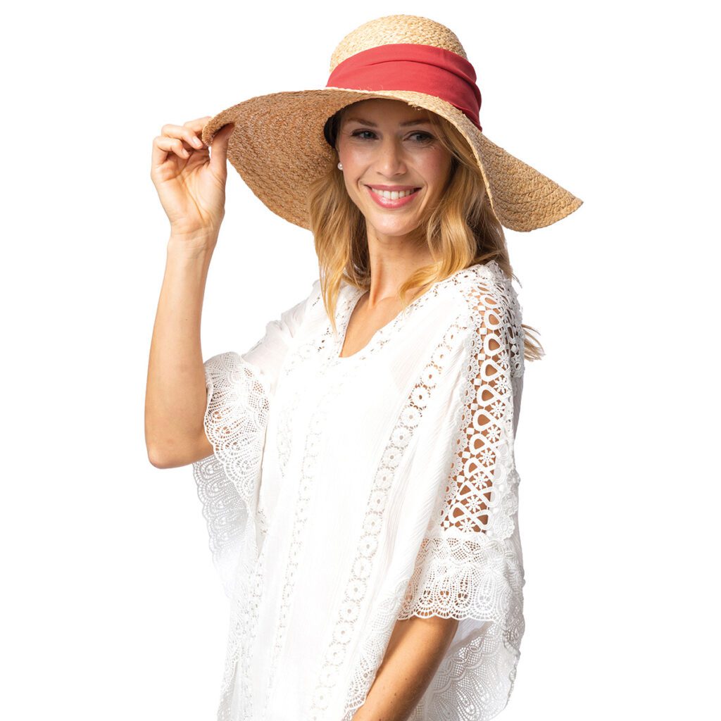 smiling blonde woman with a large raffia hat