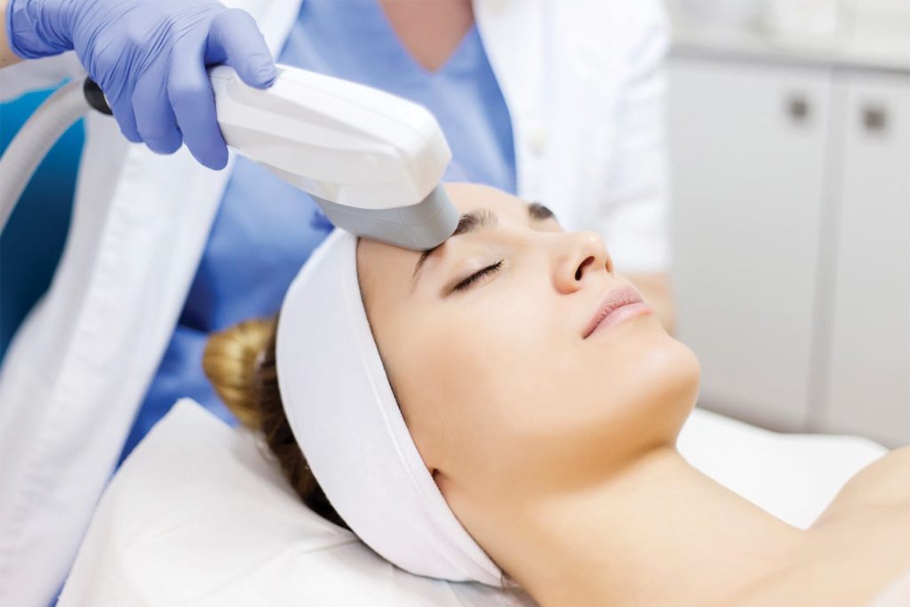 woman undergoing laser facial therapy