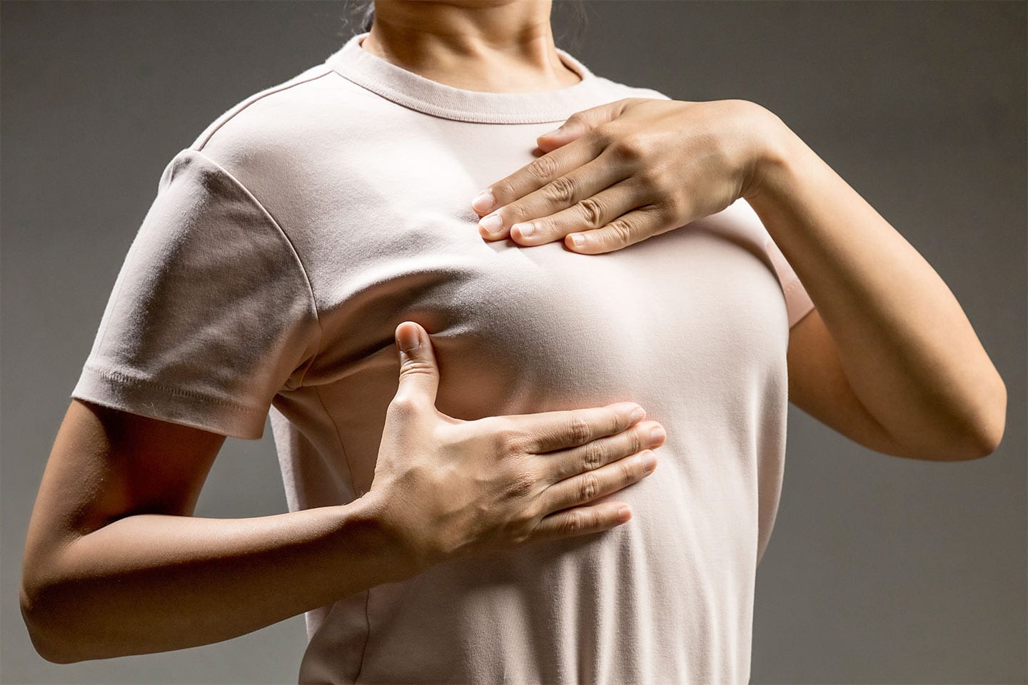 woman doing a self breast exam