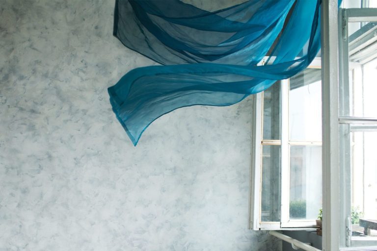 cutrains blowing in a home with open windows