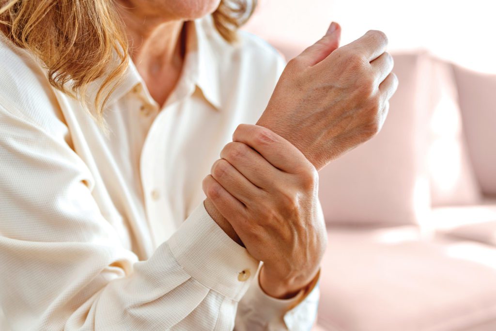Woman clutching wrist in pain