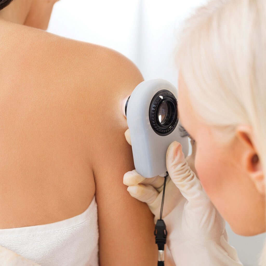 dermatologist looking at a patient's right shoulder with a tool