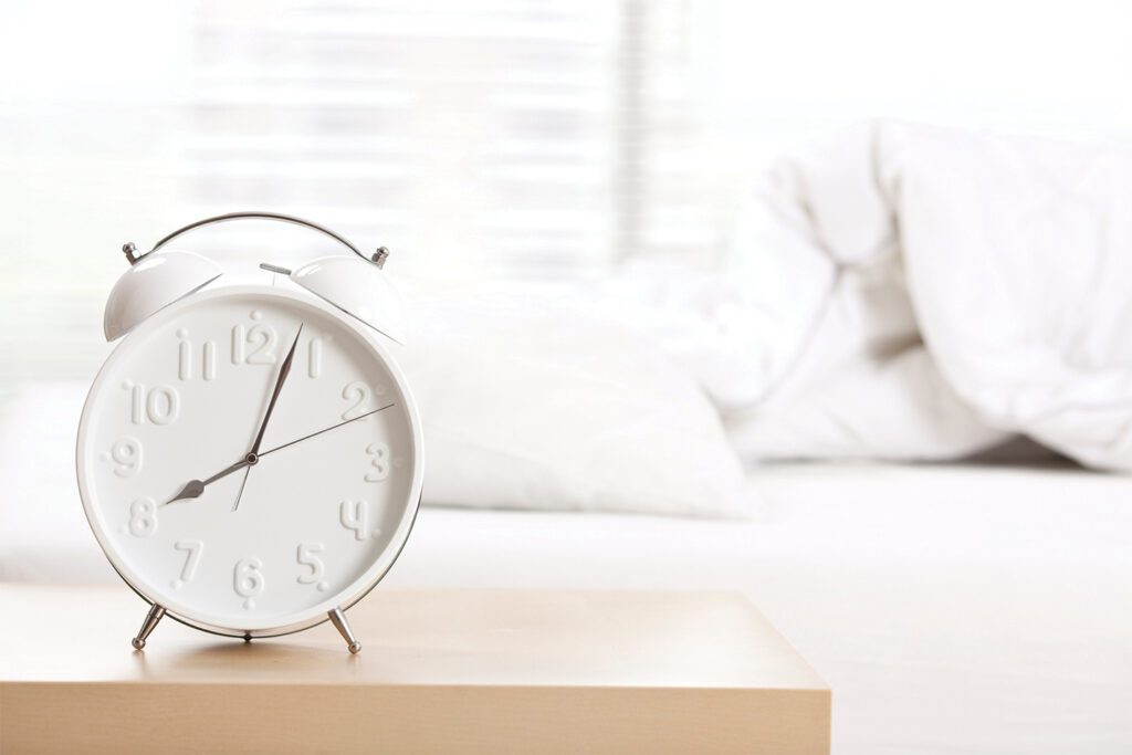 sleep and aging | alarm clock on a bedside table