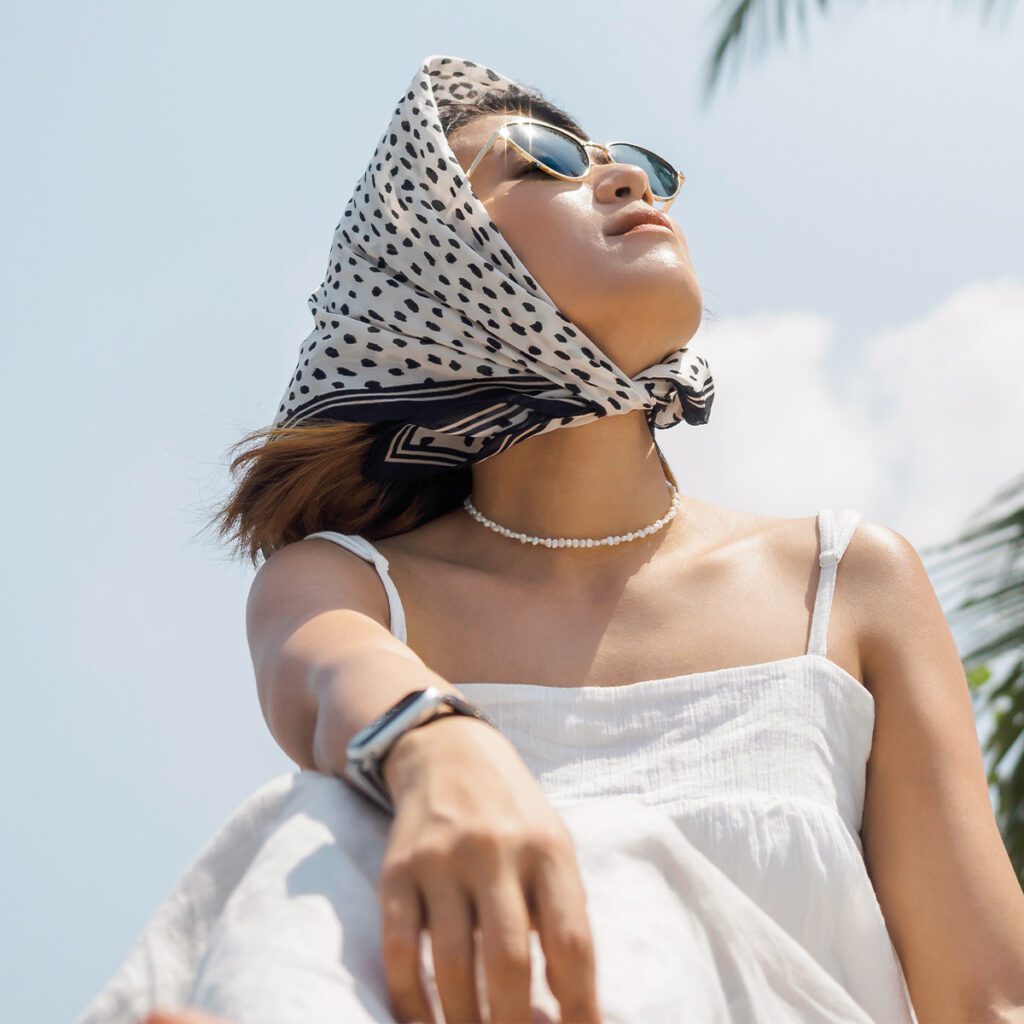 woman wearing sunglasses wearing hair scarf as a bonnet