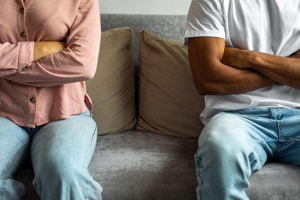 MAN AND WOMAN SITTING APART FROM EACHOTHER BECAUSE THEY ARE UPSET THAT THEY ARE IN A TOXIC RELATIONSHIP