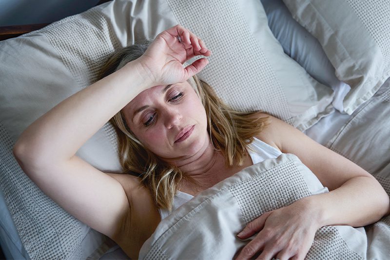 exhausted woman struggling to rest due to fatigue