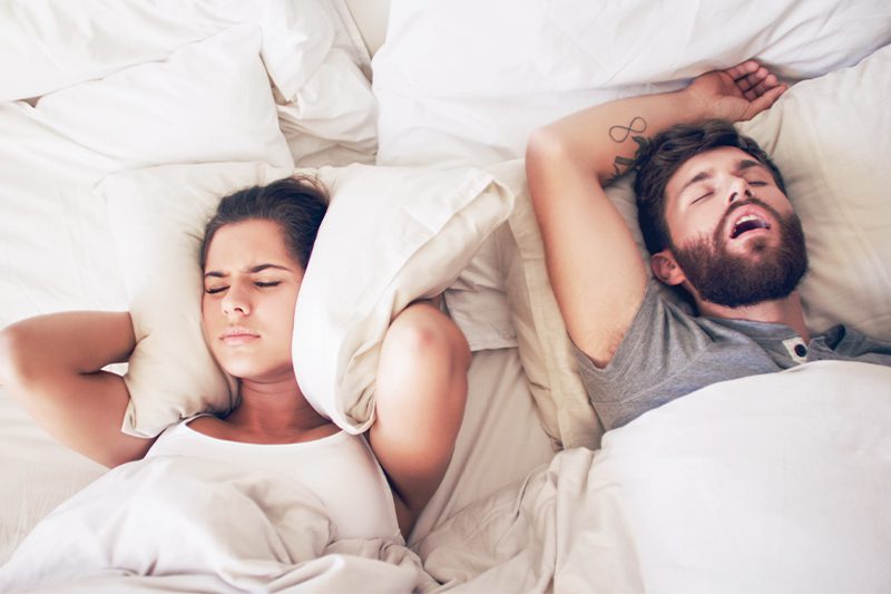woman disturbed at her husband's snoring