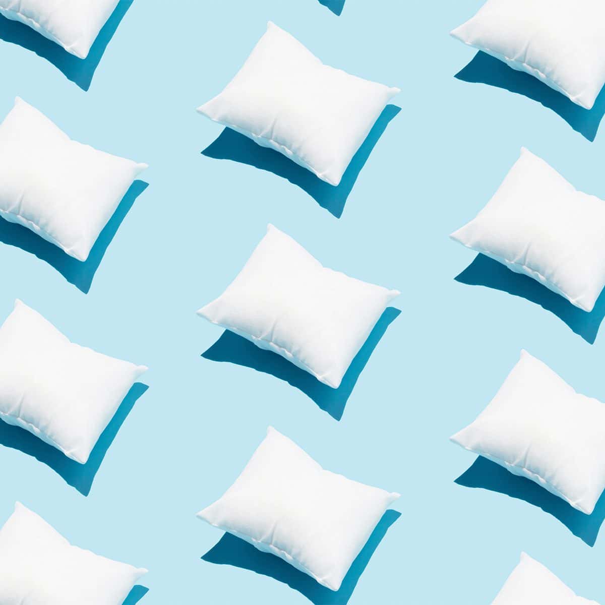 caring for your cushions | rows of white pillows in sky blue background