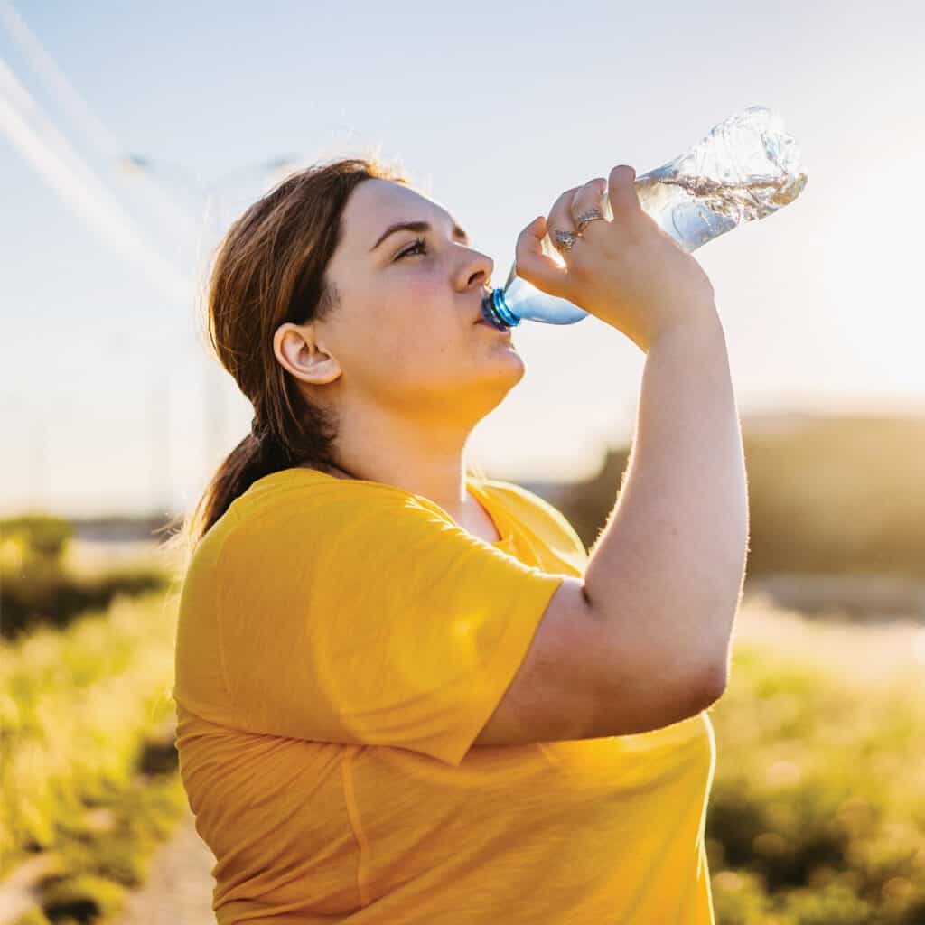 woman drinking water in heatwave