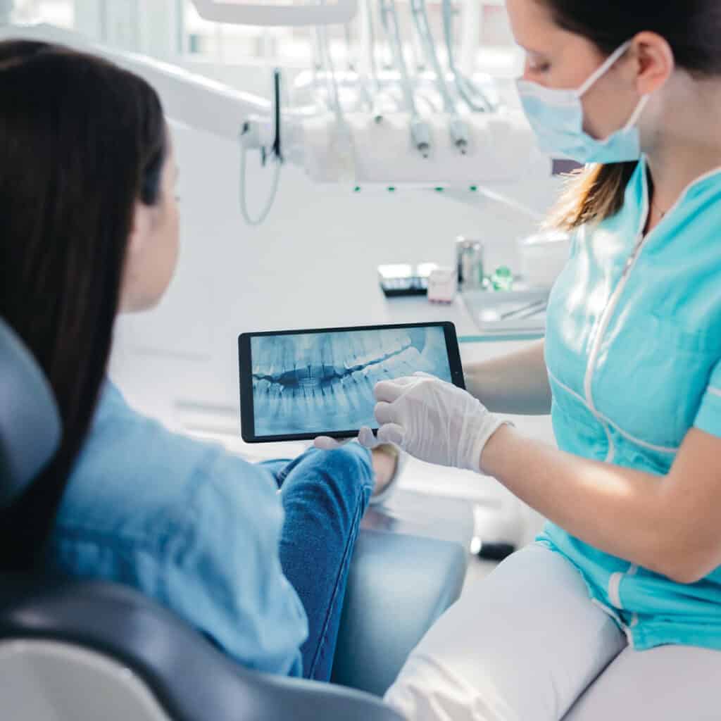 dentist discussing her xray with her patient