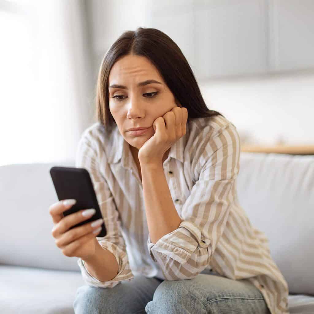 woman feeling FOMO while browsing social media